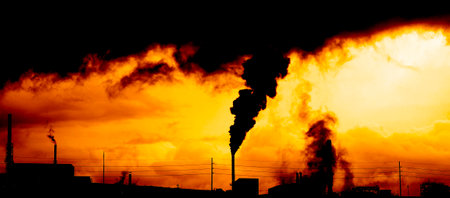 Pollution from smoke stack at a factory production bad for the environmentの写真素材