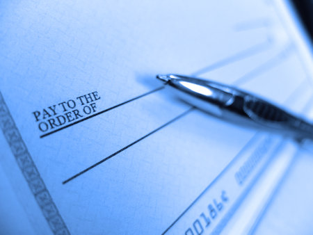 Writing check with pen for payment of dollar amount pay to the order of payの写真素材
