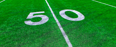 Football field green grass white yard markers to touchdown competition gameの写真素材