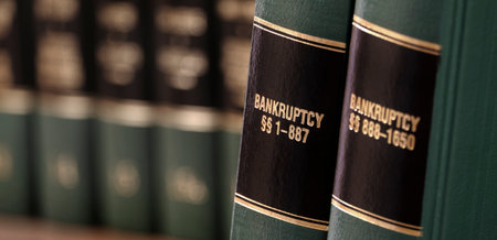 Bankruptcy law books on shelf bookshelf for legal referenceの写真素材
