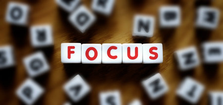 Word focus mixed with letters representing achievement through precise effort and hard workの写真素材