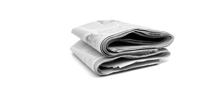 Stacked up newspaper isolated on white background breaking news written communicationの写真素材