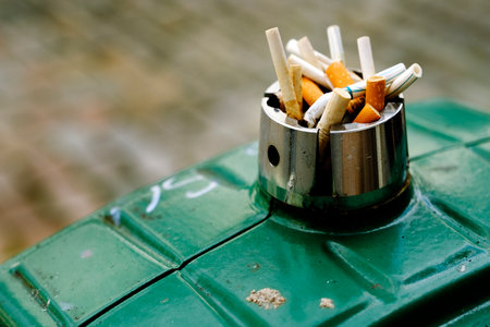 Detail of Pile of dirty cigarette butts in ashtray burned out and smoked trash discardedの写真素材