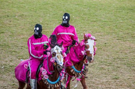 The cavalhadas in the city of PirenÃ³polis is a popular tradition that takes place every year, the main attraction of this party is the masked ("Mascarados de PirenÃ³polis"), people dress in masks and colorful clothes and go on horseback through the city,のeditorial素材