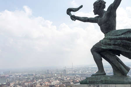 Statue of a person on the background of the city.の写真素材