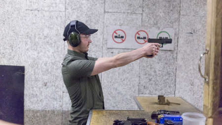 man training at the shooting range with assault riffle, sniper, rocket launcherの写真素材