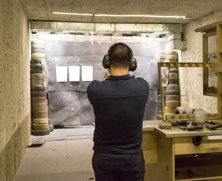 man training at the shooting range with assault riffle, sniper, rocket launcherの写真素材