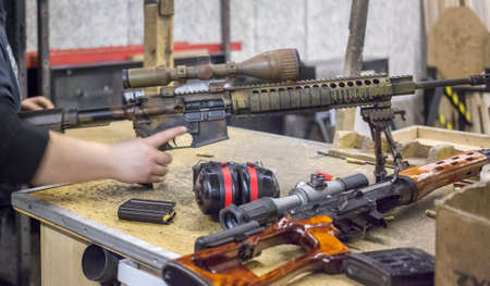 man training at the shooting range with assault riffle, sniper, rocket launcherの写真素材