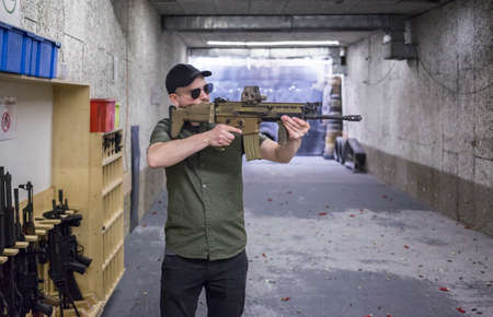 man training at the shooting range with assault riffle, sniper, rocket launcher