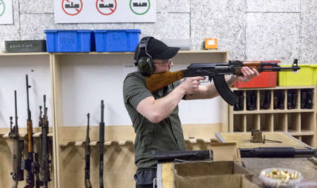 man training at the shooting range with assault riffle, sniper, rocket launcherの写真素材