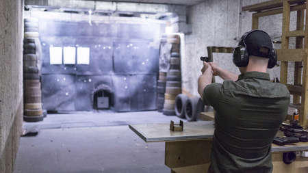 man training at the shooting range with assault riffle, sniper, rocket launcherの写真素材