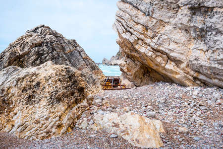 red orange sedimentary rocks on adriatic sea, budva riviera montenegro turquoise water beach and...