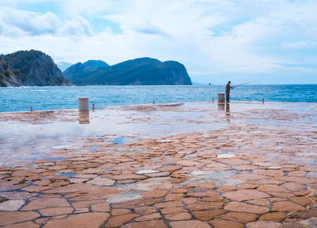 A man fishing on the coast of the Black Sea in Crimea.