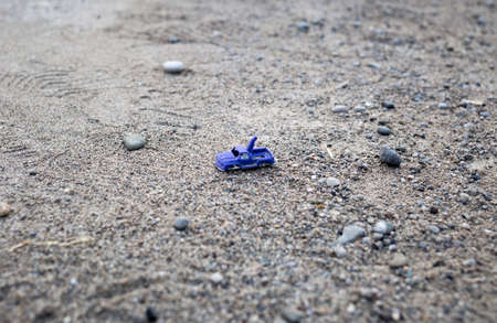Blue plastic toy on the sand. Selective focus.の写真素材