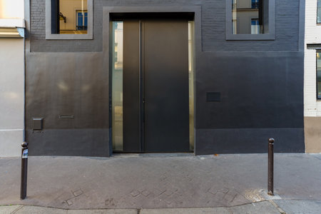 Modern black door on the facade of an apartment building. Nobody insideの写真素材