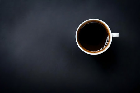Coffee cup on black background. Top view with copy spaceの素材