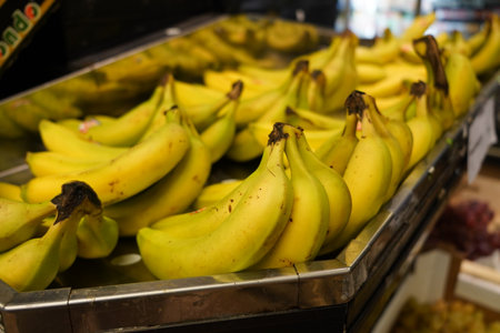 Bunch of bananas on a counter in a supermarket. Selective focus.の写真素材