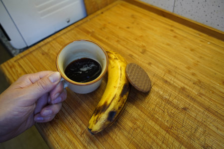 Cup of coffee and banana on a wooden table, stock photoの写真素材
