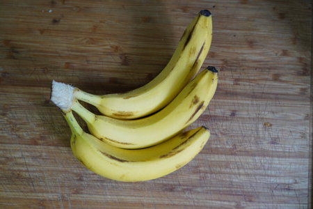 Bunch of bananas on a wooden board. Selective focus.の写真素材
