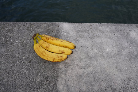 Bananas on the concrete floor by the sea. Selective focus.の写真素材