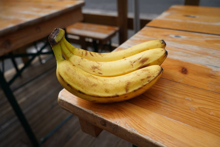Bananas on a wooden table in a cafe. Selective focus.の写真素材