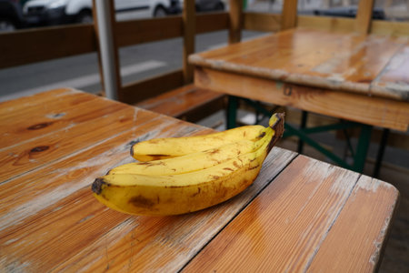 Bananas on a wooden table in a coffee shop, Thailand.の写真素材