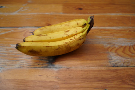 Bunch of bananas on a wooden background. Selective focus.の写真素材