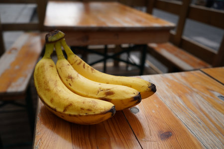 Bunch of bananas on a wooden table. Selective focus.の写真素材