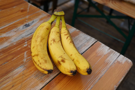 Bunch of bananas on a wooden table. Selective focus.の写真素材