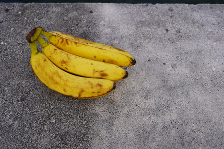 Bunch of bananas on the cement floor. Copy space for text.の写真素材