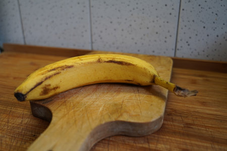 Banana on a wooden chopping board, close-up, selective focusの写真素材