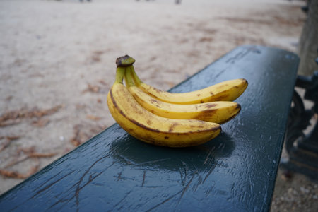 Bananas on a bench in a park. Selective focus.の写真素材