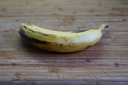 Ripe banana on a wooden cutting board. Close-up.の写真素材