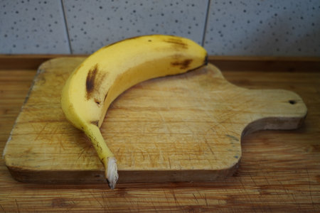 Ripe banana on a cutting board in the kitchen. Healthy food.の写真素材