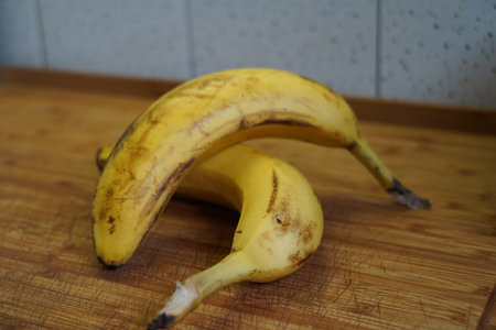 Bunch of bananas on a cutting board. Selective focus.の写真素材