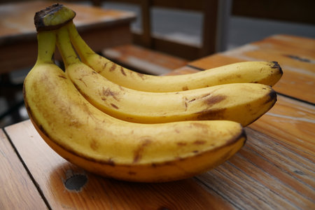 Bunch of bananas on a wooden table. Selective focus.の写真素材