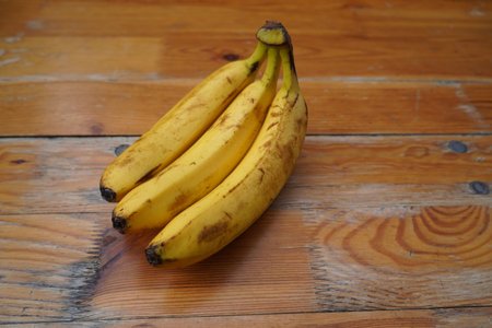 Bunch of bananas on a wooden background. Ripe bananas on a wooden background.の写真素材