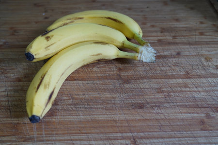 Bunch of bananas on a cutting board. Selective focus.の写真素材