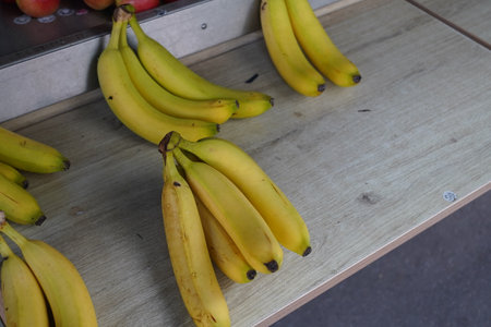 Bunch of bananas on a wooden table in a supermarket. Selective focus.の写真素材