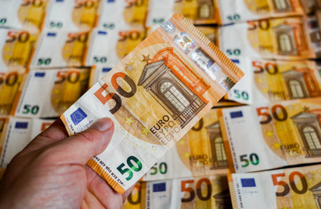 Euro banknotes in the form of a fan in the hands of a man