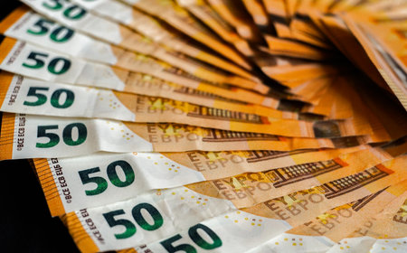 Euro banknotes on a dark background. Close-up of moneyの写真素材