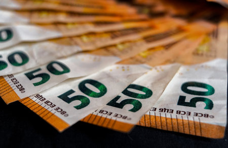Fifty euro banknotes on a dark background close up. Shallow depth of fieldの写真素材