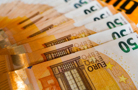 Euro banknotes on a yellow background close-up. Money backgroundの写真素材