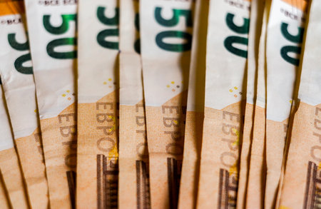 Euro banknotes stacked in a pile, close-up, macro