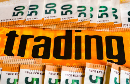 "trading" is laid out in a row of banknotes.の写真素材