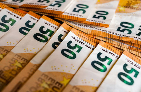 Euro banknotes stacked in a row. Money background. Close up.の写真素材