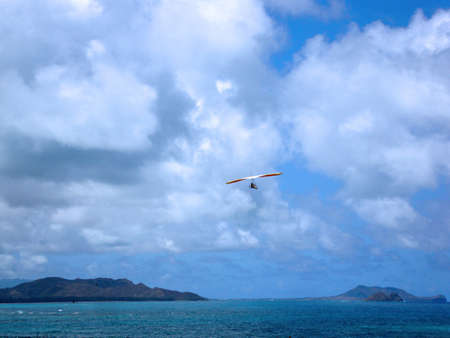 Hang glider soars over Waimanalo Bay on a great day.  Oahu, Hawaiiの写真素材