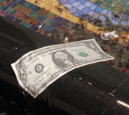 one dollar bill stuck in a waterfall in a fountian in Las Vegas.