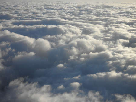 floating above and on top of fluffy curvy clouds as far as the eye can see