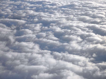 floating above and on top of fluffy curvy clouds as far as the eye can seeの写真素材